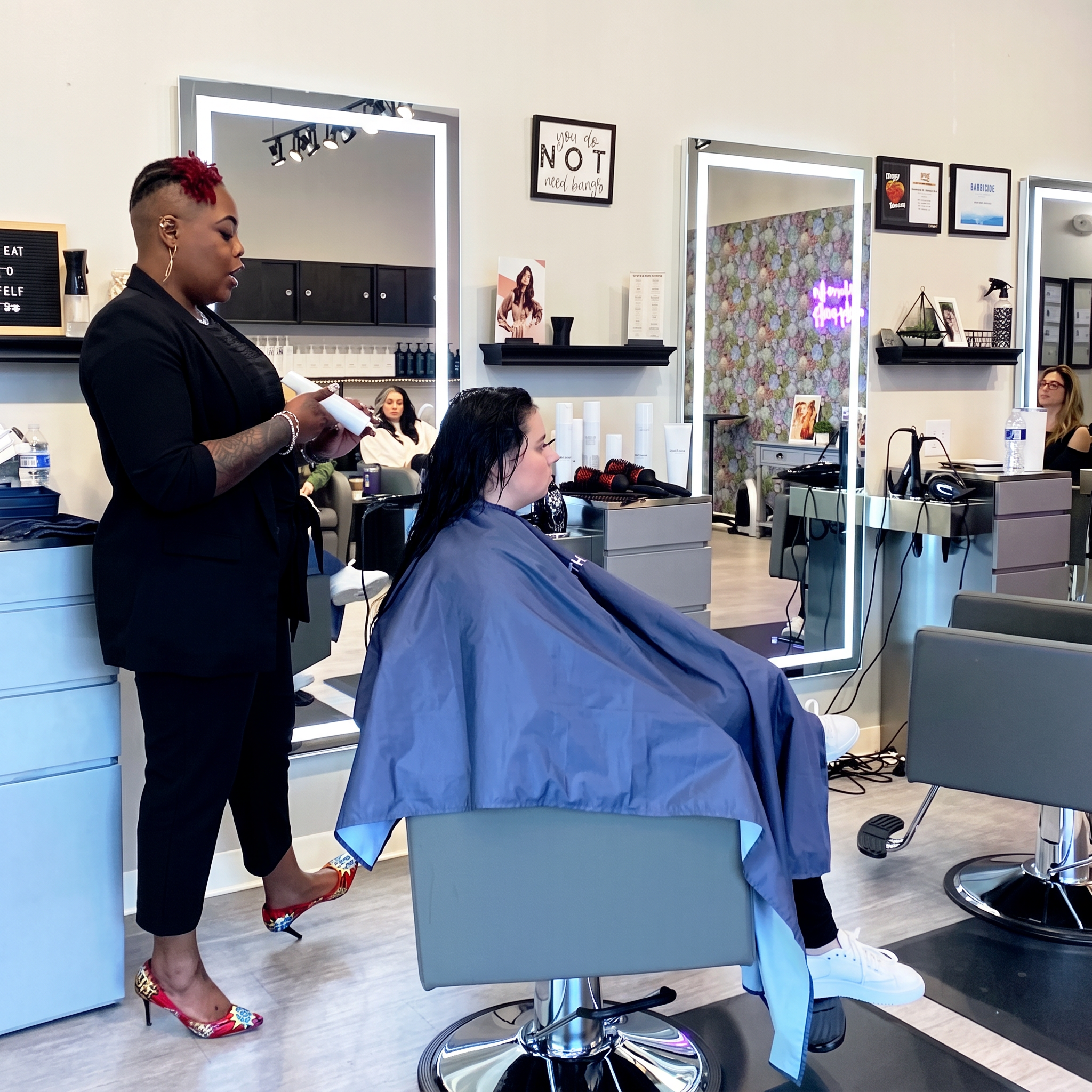 Hairstylist working with a client in the salon