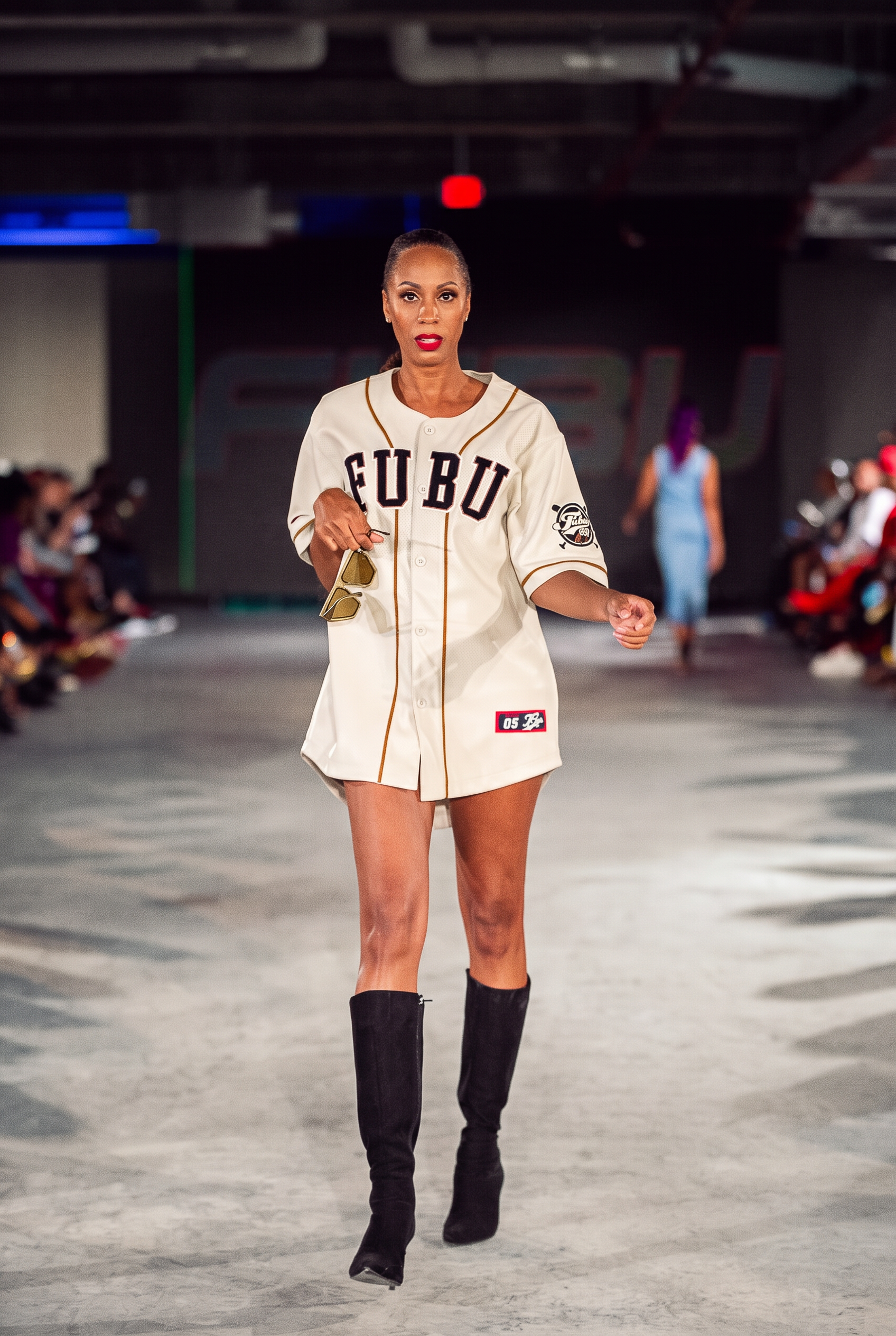 Model with a sleek ponytail walking the Atlanta fashion runway