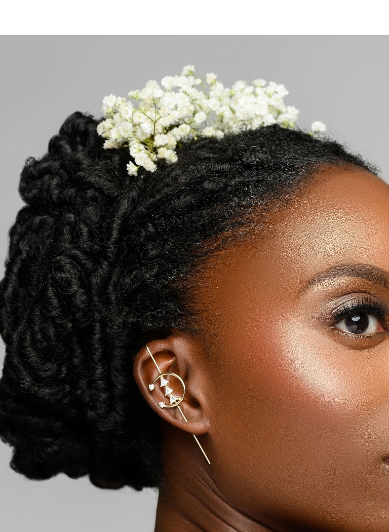 Bridal beauty portrait with a textured updo and delicate flowers